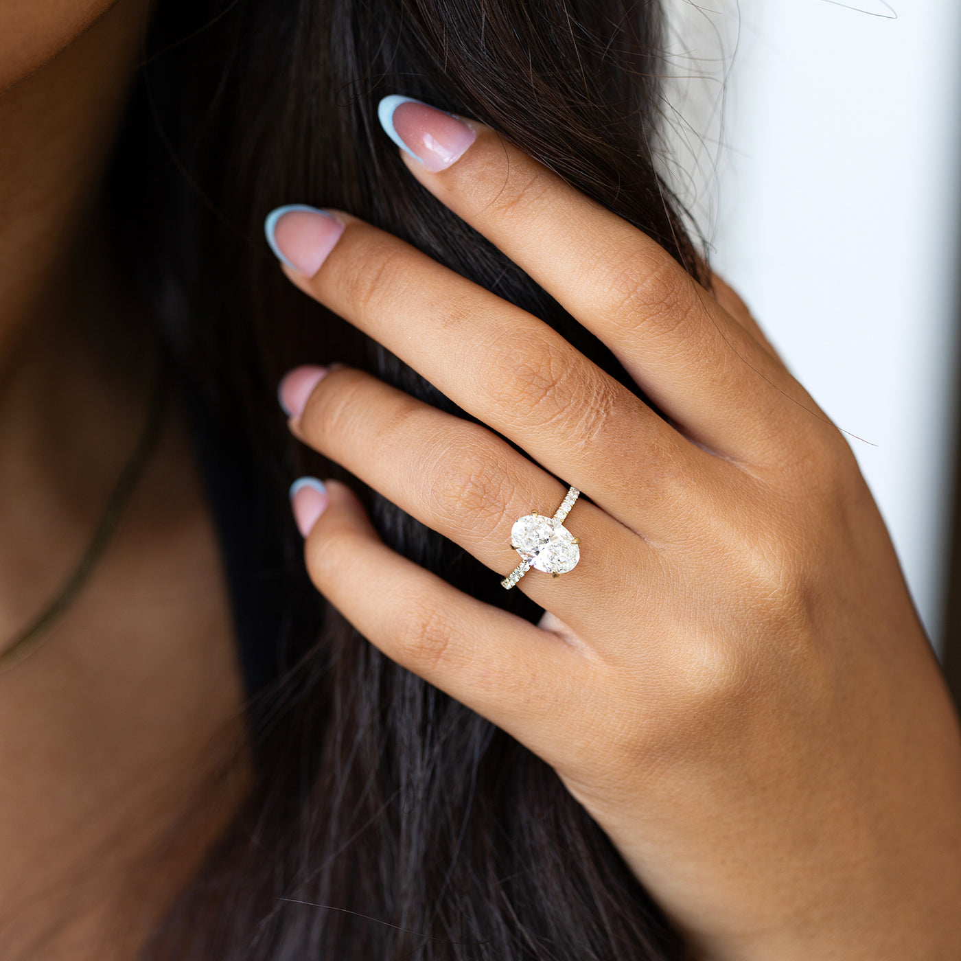 Classic 14K/18K gold Oval cut lab-grown Diamond engagement ring, set with sparkling 0.18 CT side diamonds.