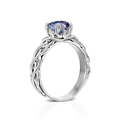 white gold knot ring with a purple gemstone on a white background