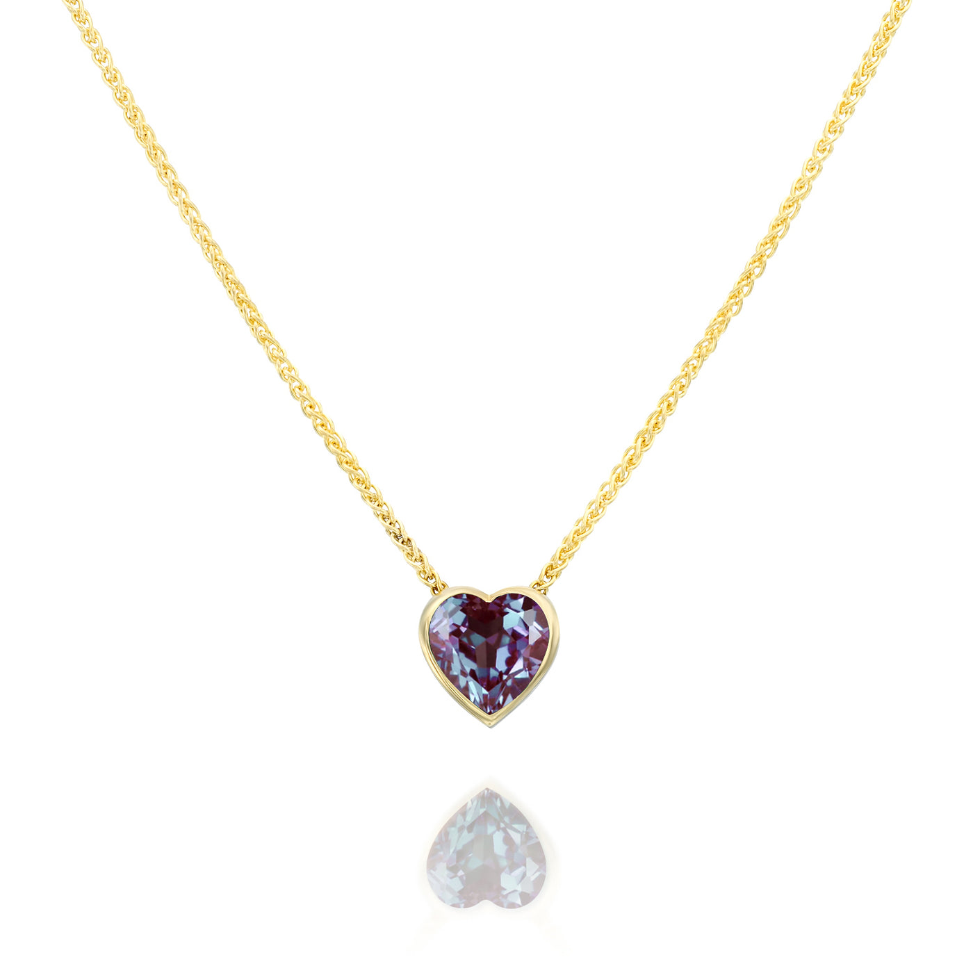 Gold necklace with a heart-shaped Alexandrite gemstone pendant on a white background