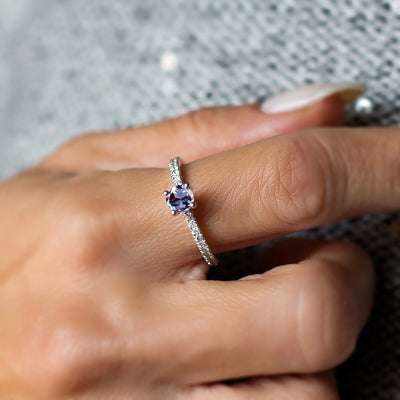 alexandrite ring with diamond worn by a woman's hand