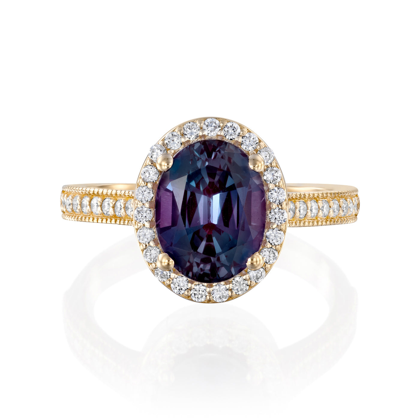 Vintage inspired yellow Gold ring with Alexandrite gemstone and diamond accents on a white background