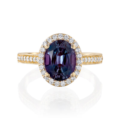 Vintage inspired yellow Gold ring with Alexandrite gemstone and diamond accents on a white background