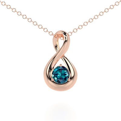 Rose gold pendant with a blue gemstone on a white background