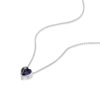 White gold necklace with a heart-shaped purple gemstone pendant on a white background
