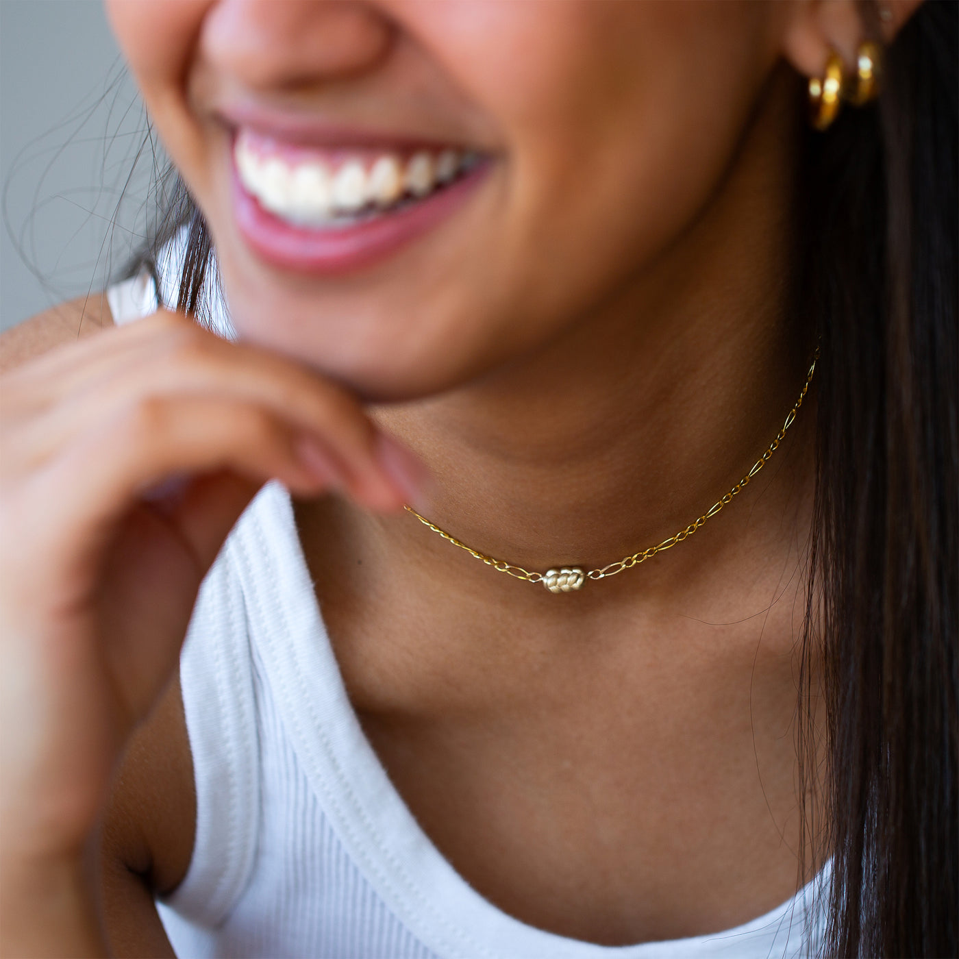 women wearing a 14K yellow Gold Challah Necklace, with an edgy chain