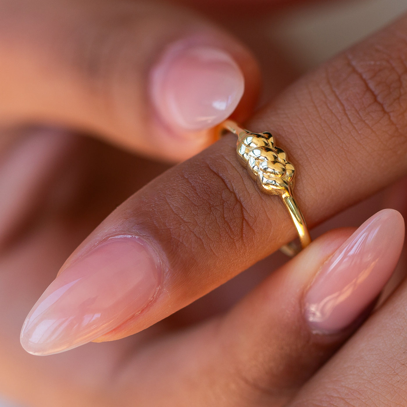 Closeup of a women wearing a 14K yellow Gold Challah Ring