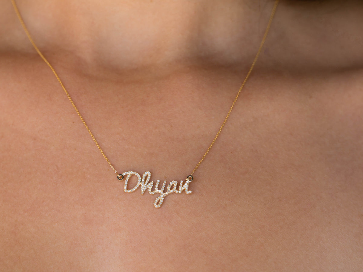 custom diamond name necklace in 14K yellow gold, worn on the body