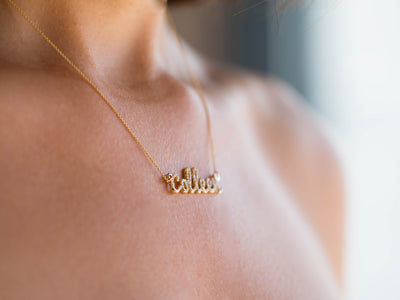 custom diamond name necklace in 14K yellow gold, worn on the body