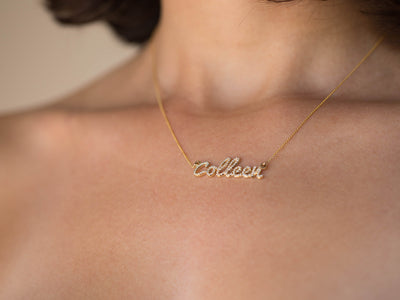 custom diamond name necklace in 14K yellow gold, worn on the body