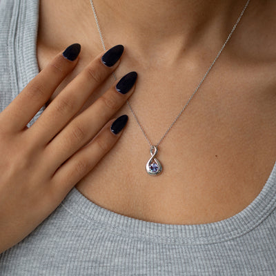 alexandrite necklace in an infinity design worn by a woman