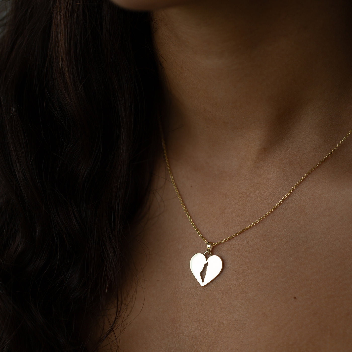 women wearing a 14K Gold Heart necklace with a map of israel on it