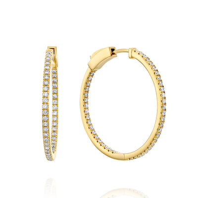 Gold hoop earrings with diamond accents on a white background