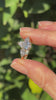 Model's hand showing sparkling pear cut diamond trilogy ring