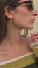 Video of a model wearing a floating diamond necklace, transitioning to a close-up of the brilliant lab-grown diamond pendant.