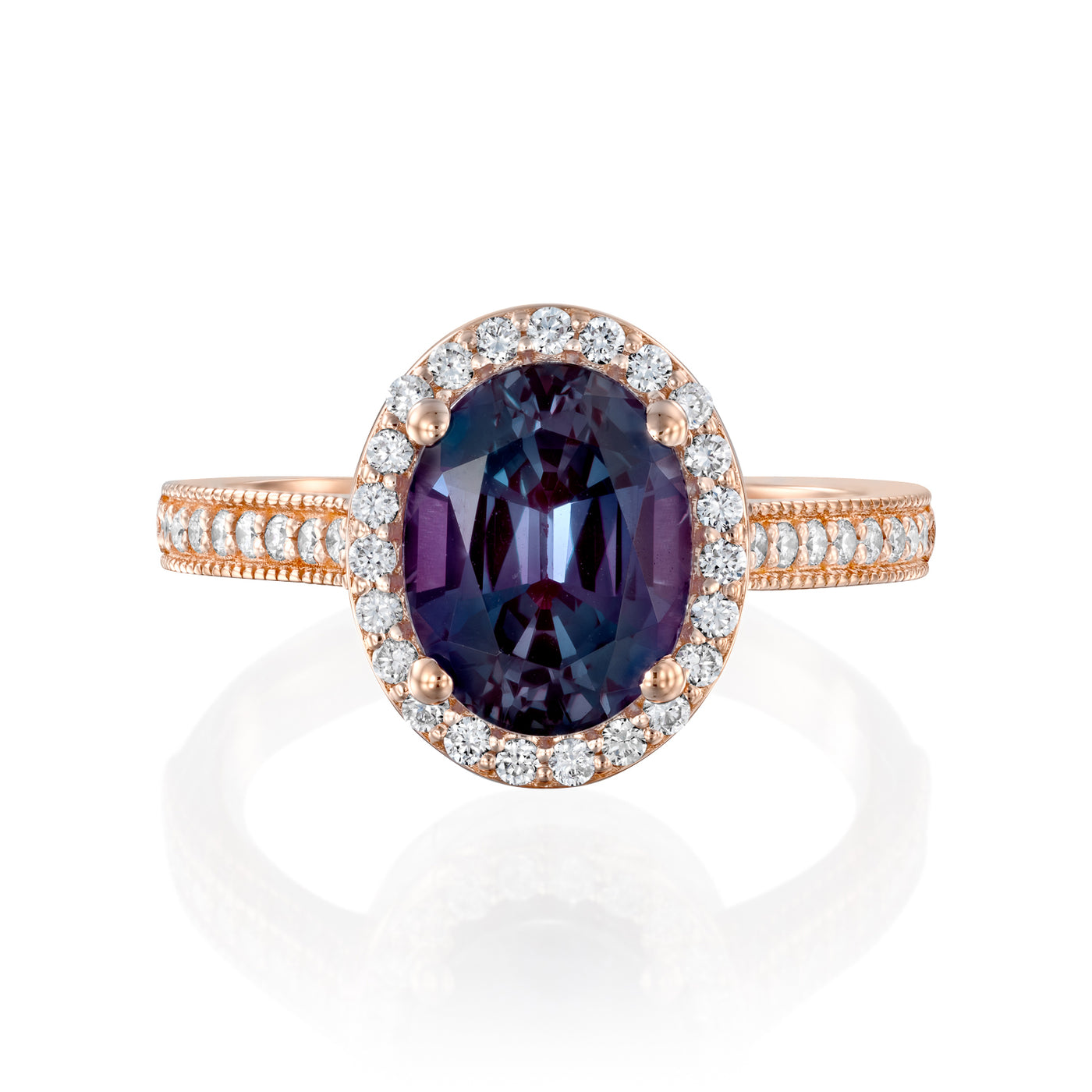 Rose gold ring with a purple gemstone and diamond halo on a white background