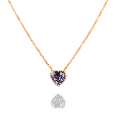 Necklace with a heart-shaped purple gemstone pendant on a white background