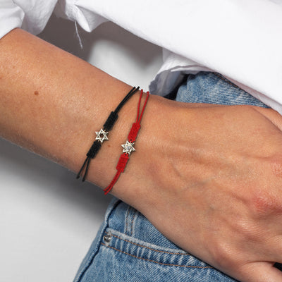 women wearing two 14K Gold Star of David Bracelet with strings, one red and one black