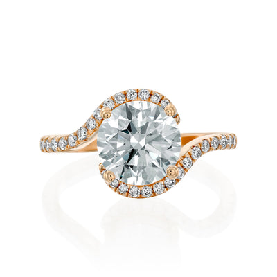 Rose gold Moissanite ring with a diamond halo on a white background