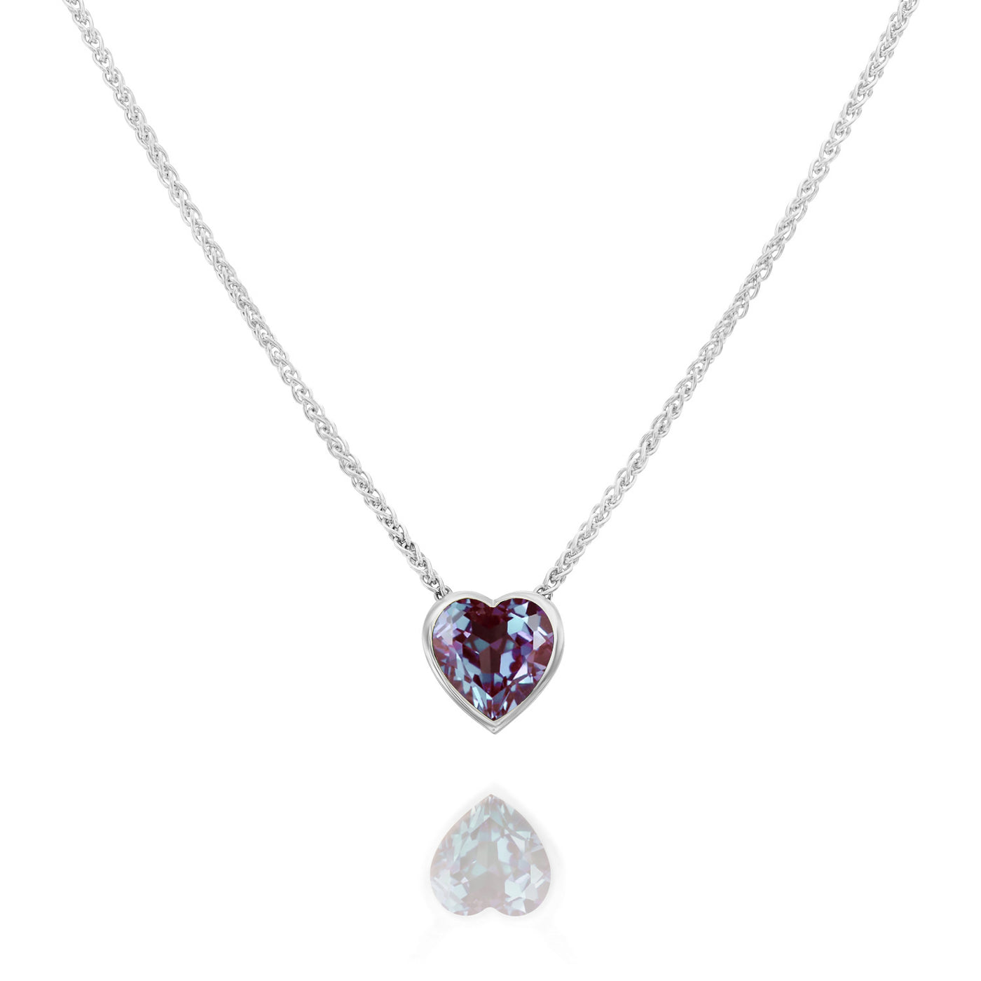 Heart-shaped gemstone necklace in white gold on a white background