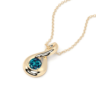 Gold necklace with a blue gemstone pendant on a white background
