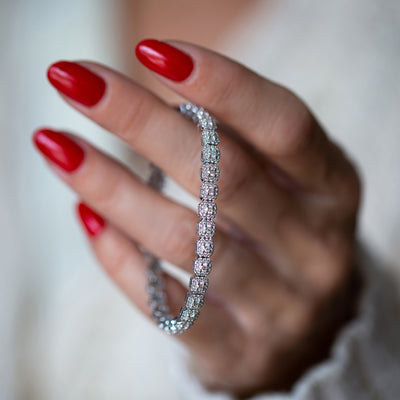 This unique diamond tennis bracelet features stunning pave set diamond clusters on cushion shape links that sparkle and shine with every movement.