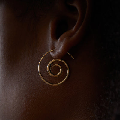Our 14K gold and diamonds spiral earrings feature a stunning boho swirl tribal design, the perfect unique hoop earrings.